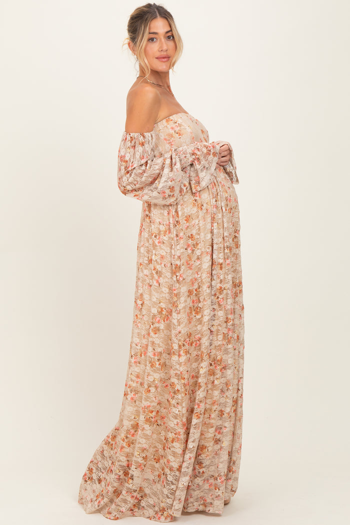 woman wearing a floral off-the-shoulder maternity maxi dress showing her baby bump