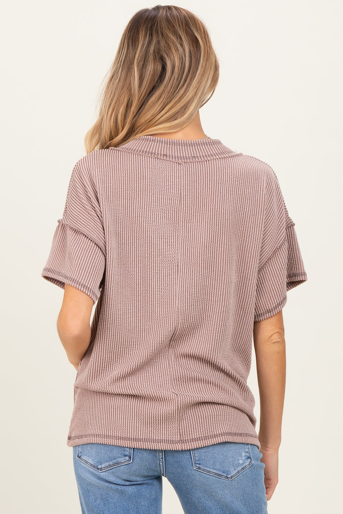 woman wearing a light brown short sleeve maternity top with ribbed texture and relaxed fit seen from the back