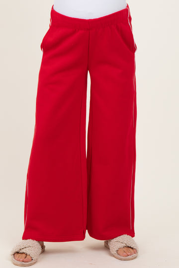 maternity wear red wide-leg sweatpants with side pockets, model wearing soft slippers