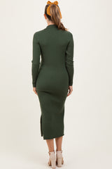 woman wearing a dark green ribbed maternity dress with long sleeves and a side slit, shown from the back