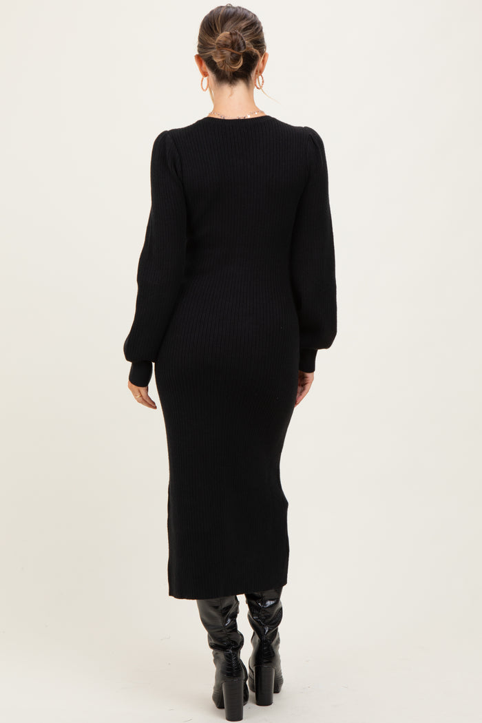 woman wearing a black ribbed maternity dress with long sleeves and a fitted silhouette, viewed from the back