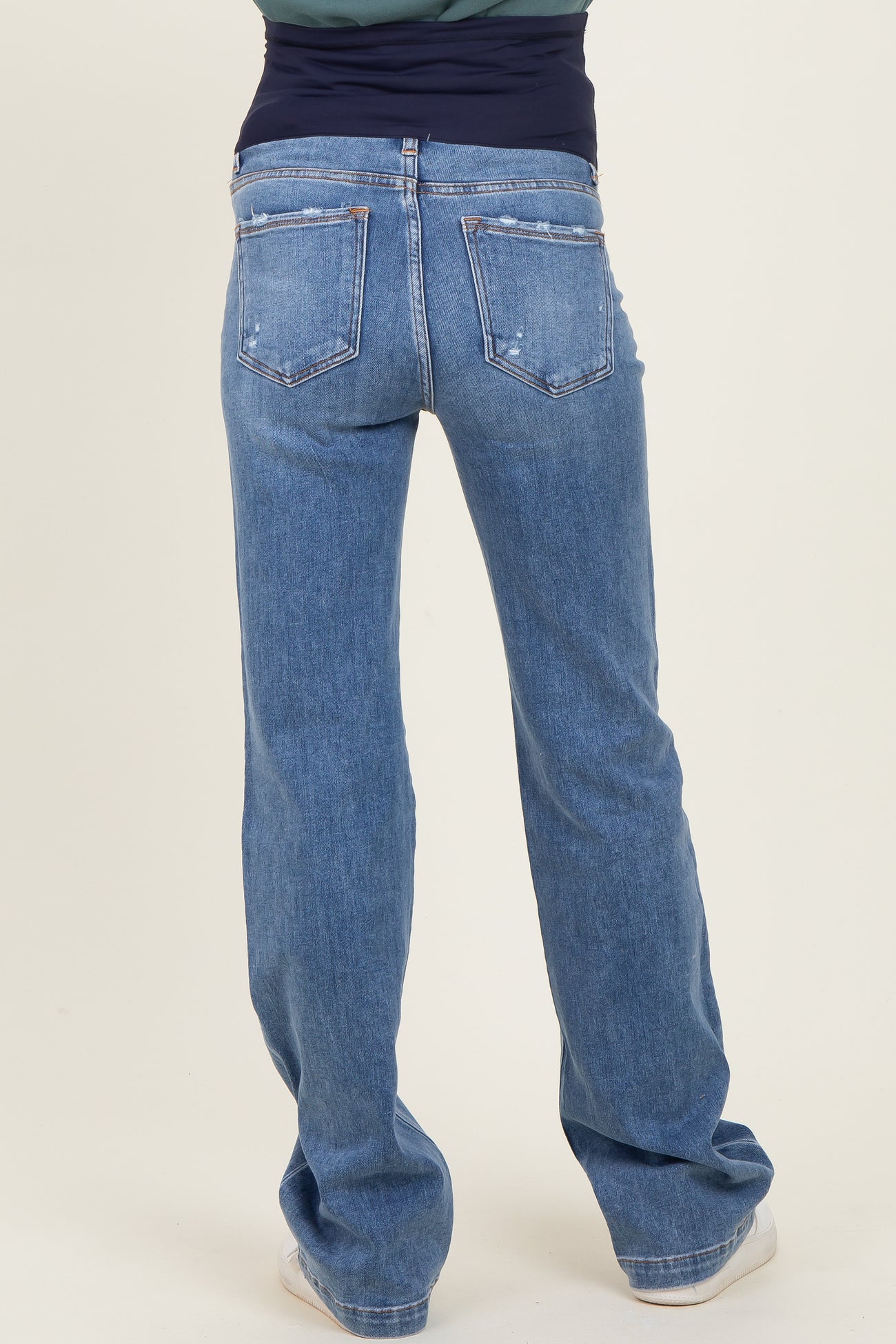 maternity wear light blue bootcut jeans shown from the back