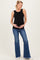 woman wearing a black ribbed maternity tank top and blue flared jeans, holding her baby bump