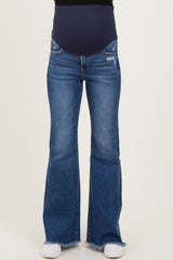 woman wearing dark blue flared maternity jeans with a stretchy belly panel and distressed details