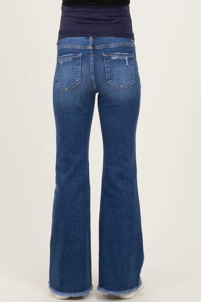 maternity wear light wash flared jeans with a distressed hem, worn by a model with a fitted top