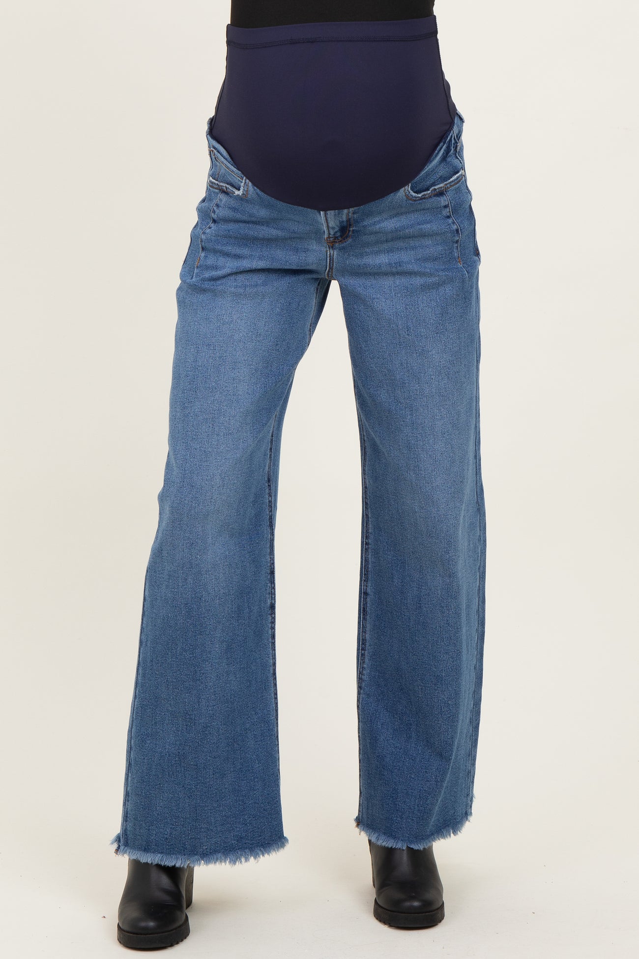 maternity wear blue wide leg jeans with a stretchy belly panel and frayed hem, worn by a model