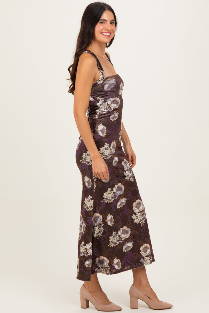 woman wearing a brown floral print maxi dress with spaghetti straps and a fitted silhouette