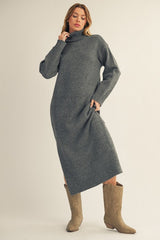 woman wearing a gray turtleneck sweater dress paired with beige cowboy boots