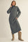 woman wearing a gray turtleneck sweater dress paired with beige cowboy boots