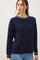 woman wearing a navy blue cable knit sweater with a contrasting collar detail and long sleeves