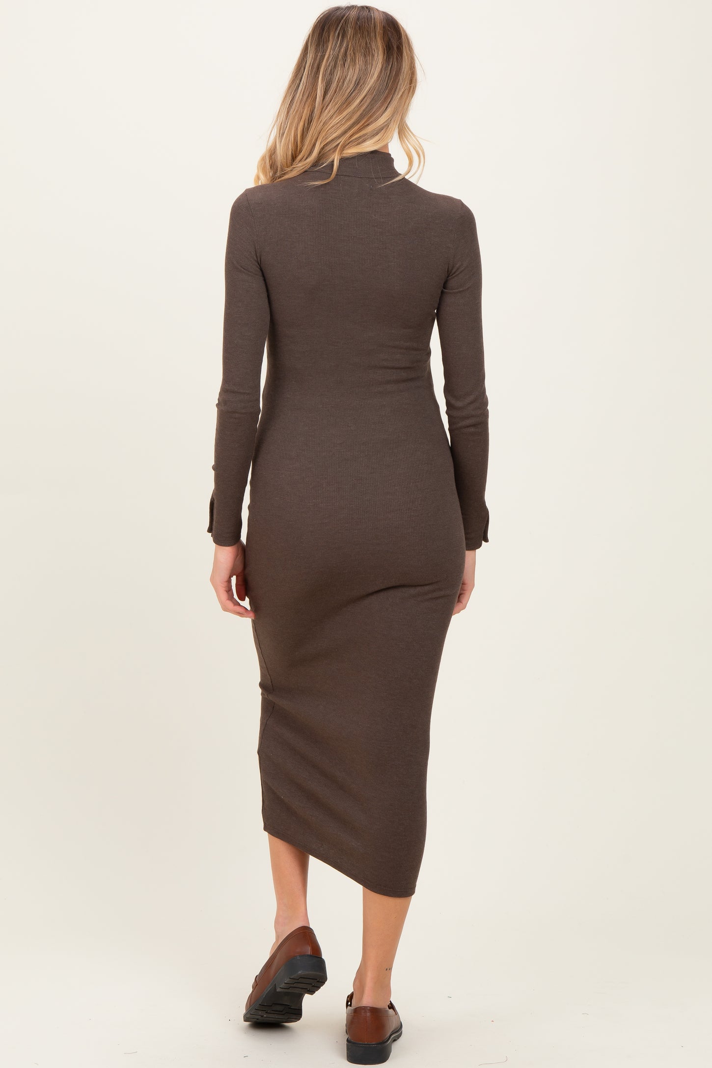 woman wearing a brown long sleeve maternity dress with a fitted silhouette and below-the-knee length from the back