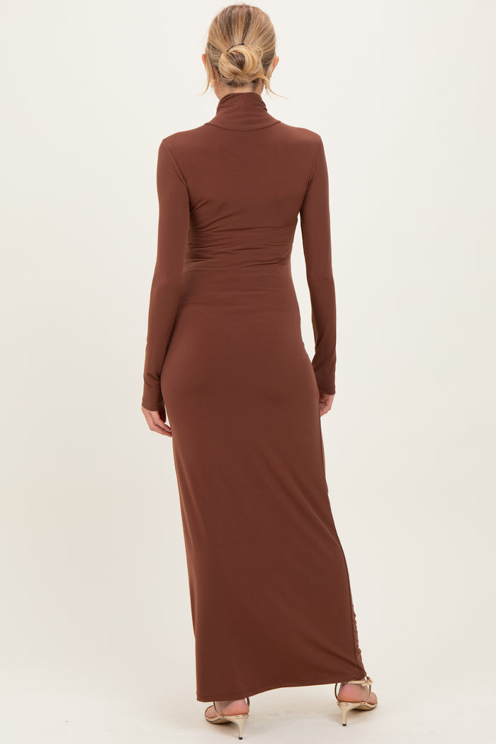 woman wearing a brown long sleeve maternity maxi dress, showing the back view with a fitted silhouette