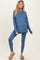 woman wearing a blue maternity activewear set, featuring a long sleeve top and leggings, with a visible baby bump