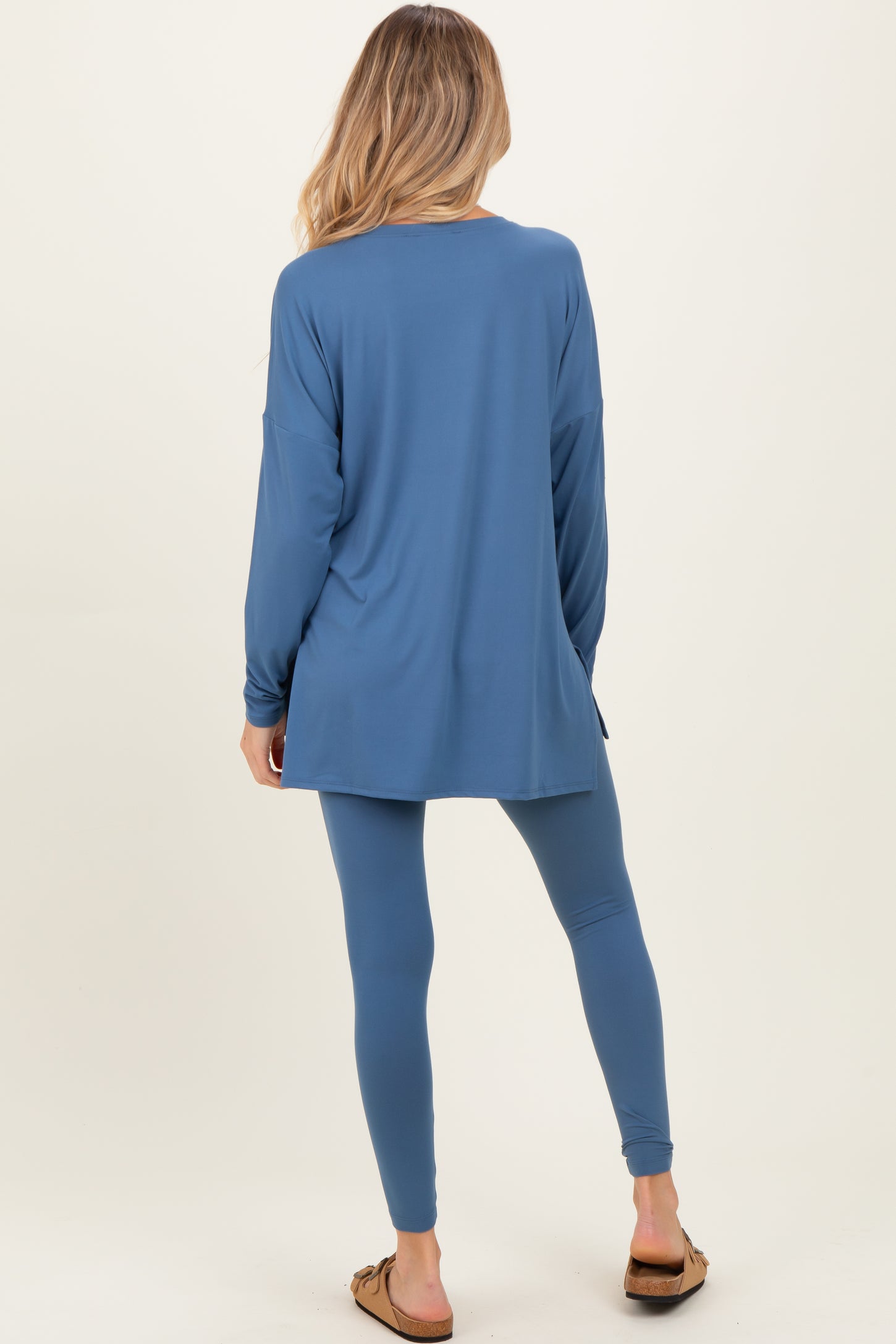 woman wearing a relaxed fit blue maternity top and matching leggings, showing a comfortable and stylish look
