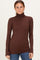 woman wearing a fitted brown long sleeve turtleneck top with a sleek design and soft fabric