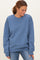 woman wearing a relaxed fit blue sweatshirt with long sleeves and a round neckline, smiling and looking down