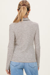 woman wearing a striped long sleeve maternity top, viewed from the back, paired with light blue jeans