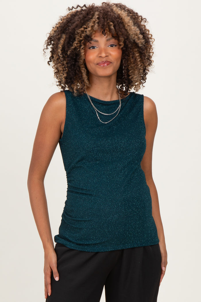 woman wearing a teal sleeveless maternity top with gathered detailing and a shiny finish, small baby bump visible