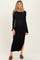 woman wearing a black long sleeve ribbed maternity dress with a side slit and a visible baby bump