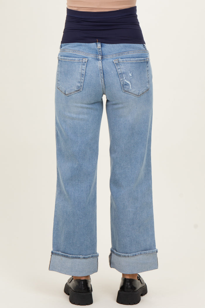 woman wearing light blue maternity wide-leg jeans with a high waistband and cuffed hems, view from the back