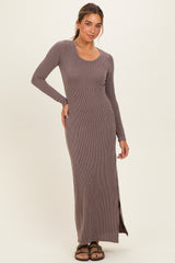 woman wearing a long sleeve brown ribbed maxi dress with side slit and a scoop neckline