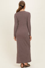 woman wearing a long sleeve ribbed brown maxi dress, seen from the back