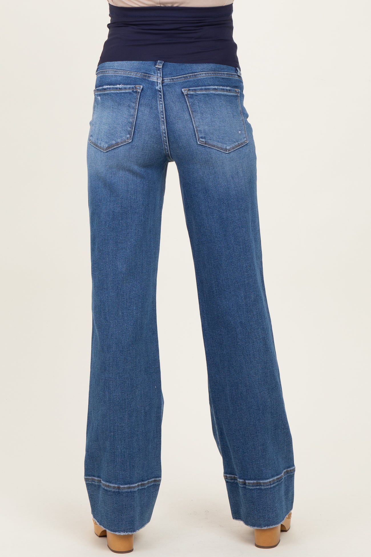 woman wearing blue maternity wide-leg jeans viewed from the back with a supportive waistband
