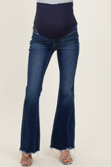 woman wearing dark blue maternity flared jeans with a navy blue over-the-belly band and frayed hem