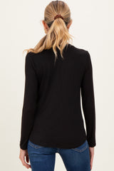 woman wearing a black long sleeve maternity top, view from the back with a sleek design and fitted style