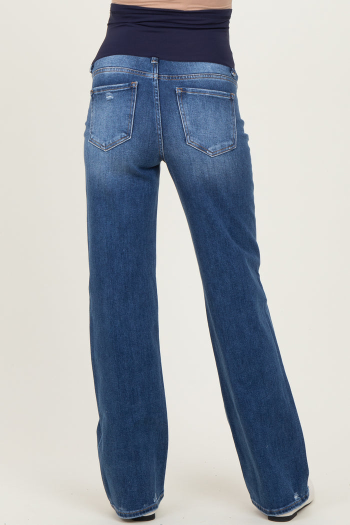 woman wearing blue maternity jeans with a wide-leg style and a support panel for the baby bump, shown from the back