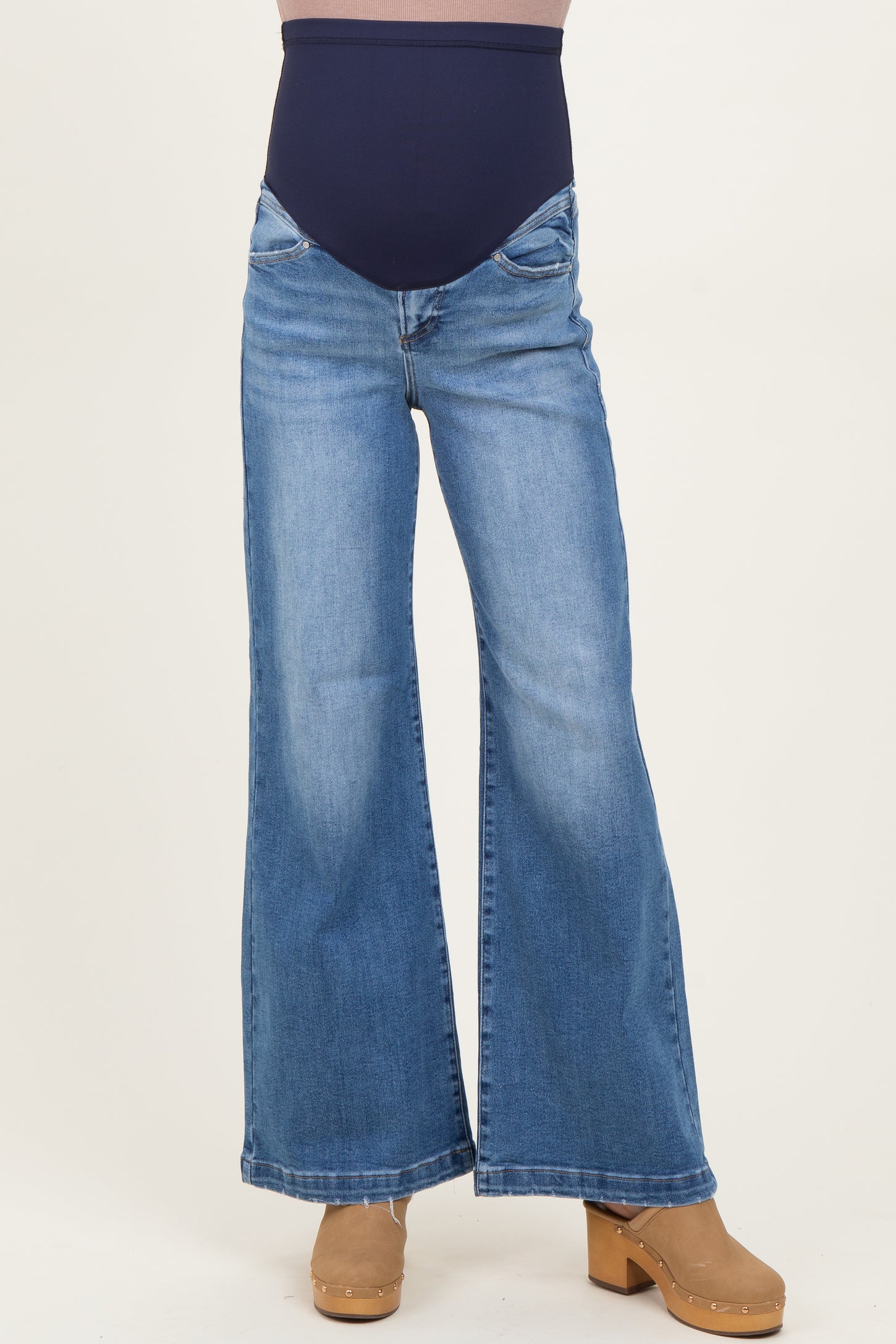 woman wearing maternity blue wide leg jeans with a high waist and stretchy belly panel