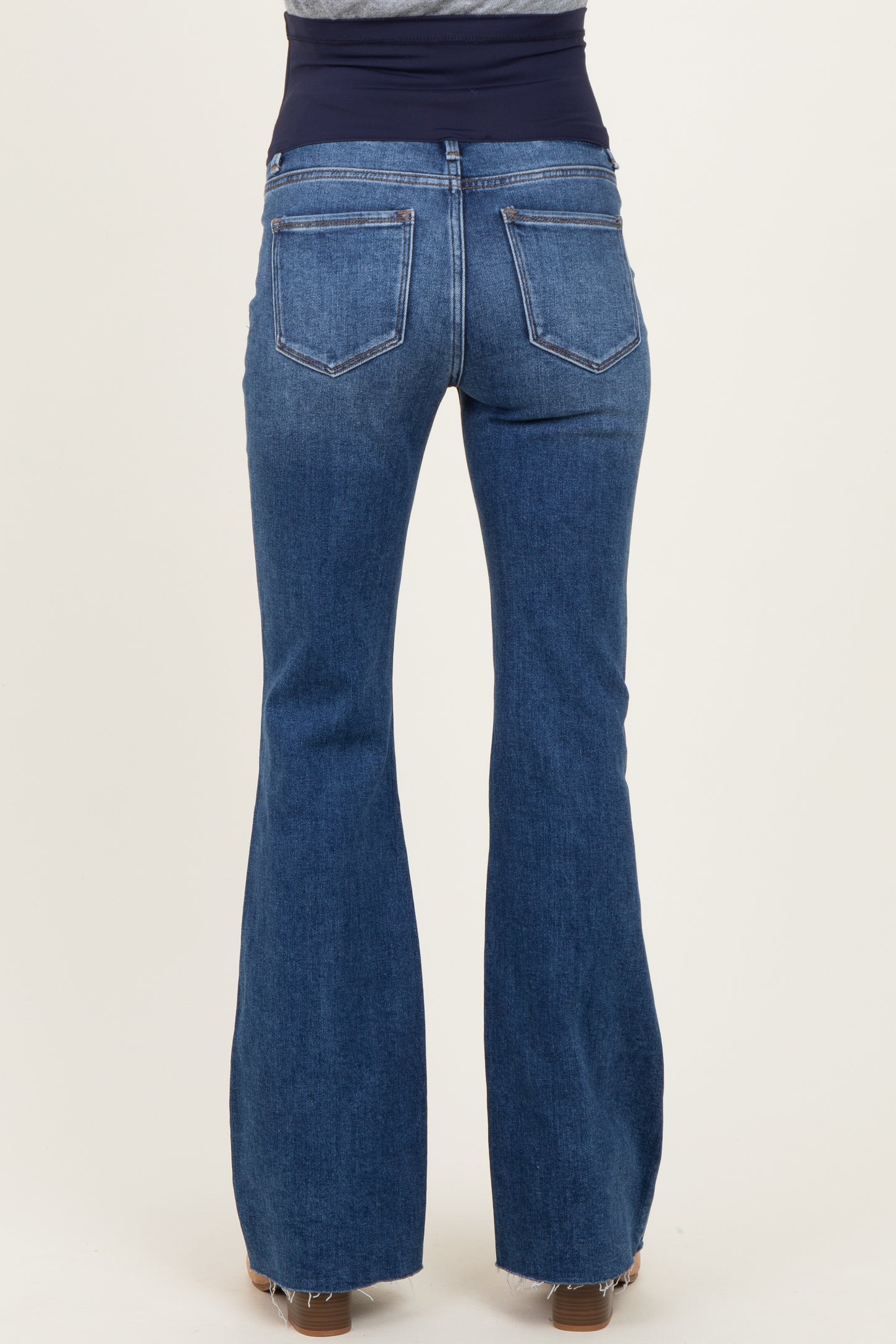 maternity wear blue flared jeans with a stretchy navy waistband, showing the back view