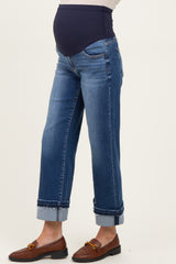 woman wearing a pair of dark blue maternity jeans with a supportive belly band and cuffed hems