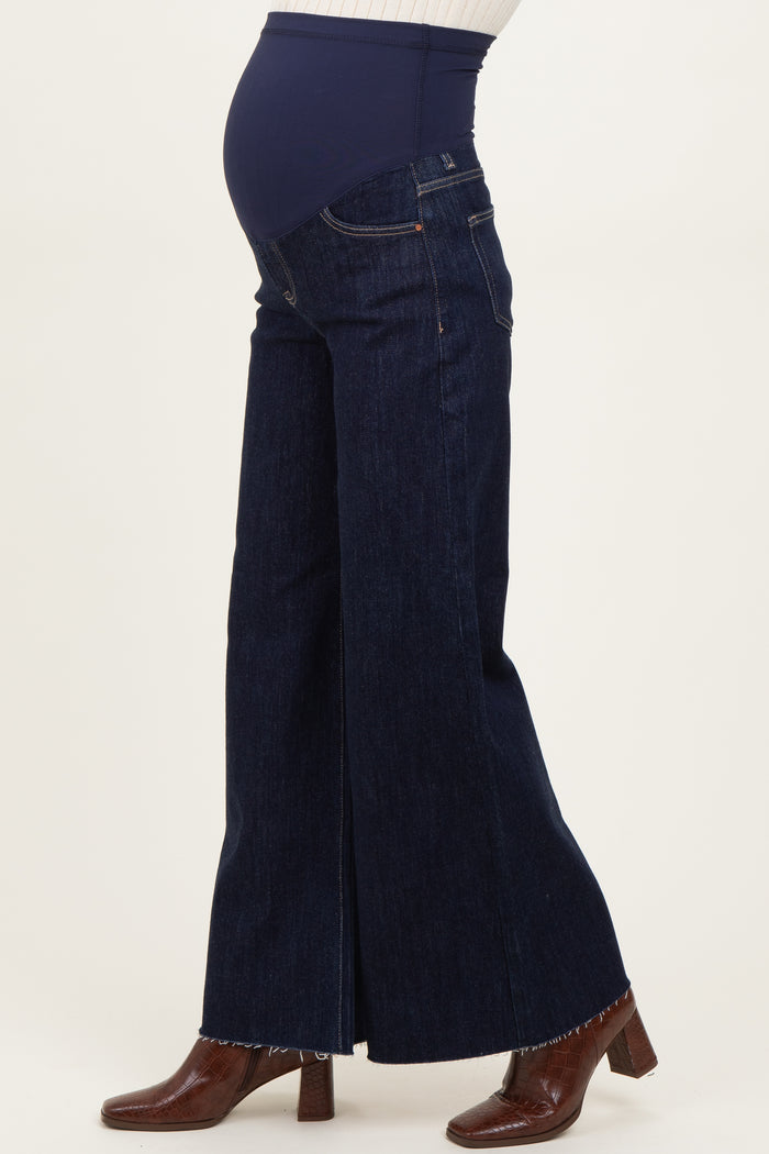 woman wearing dark blue maternity wide-leg jeans with a supportive belly panel and a visible baby bump