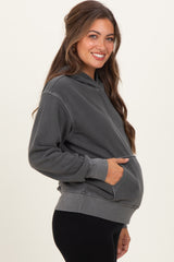 woman wearing a dark gray maternity hoodie with a front pocket and baby bump visible