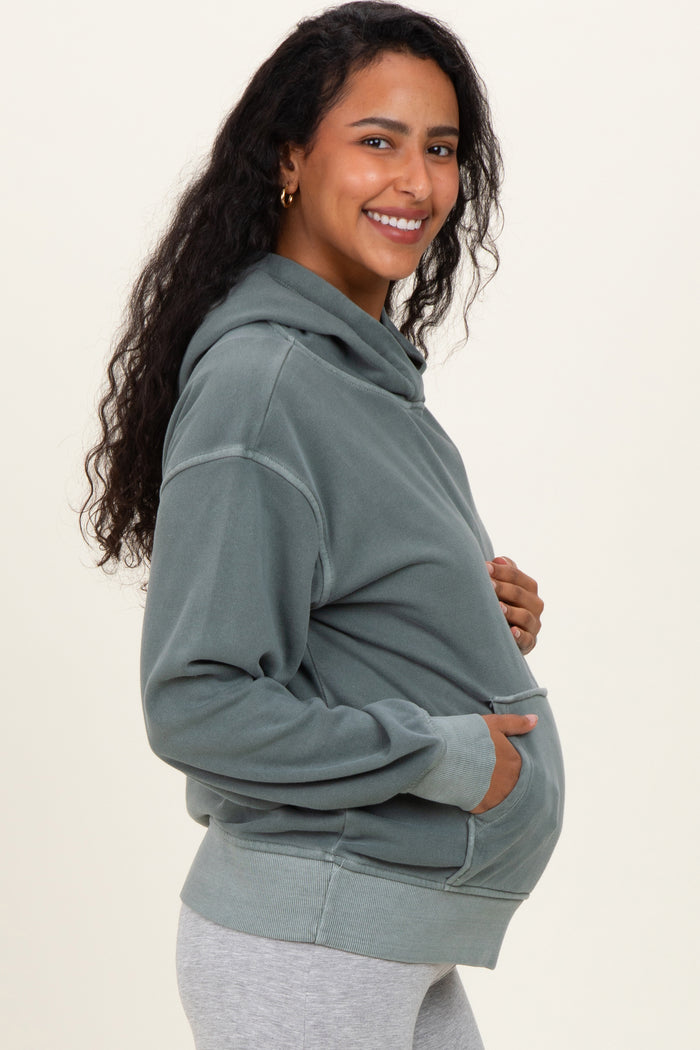 woman wearing a grey maternity hoodie with a front pocket and a visible baby bump