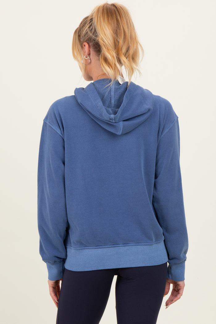 woman wearing a blue maternity hoodie with a relaxed fit and a hood, seen from the back