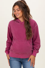 woman wearing a raspberry pink maternity hoodie with a front pocket and relaxed fit