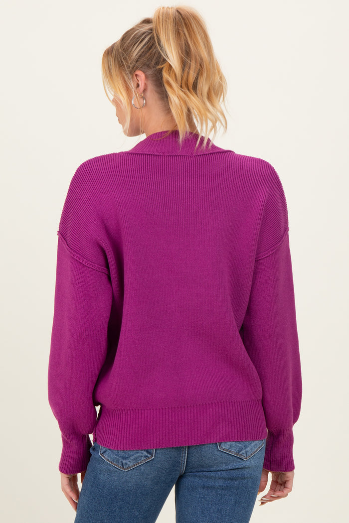 woman wearing a magenta maternity sweater with a relaxed fit and balloon sleeves, showing the back view
