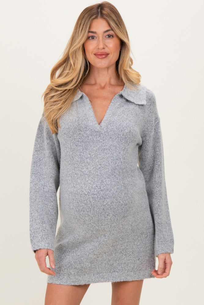 woman wearing a gray maternity dress with a collar and long sleeves, showcasing her baby bump