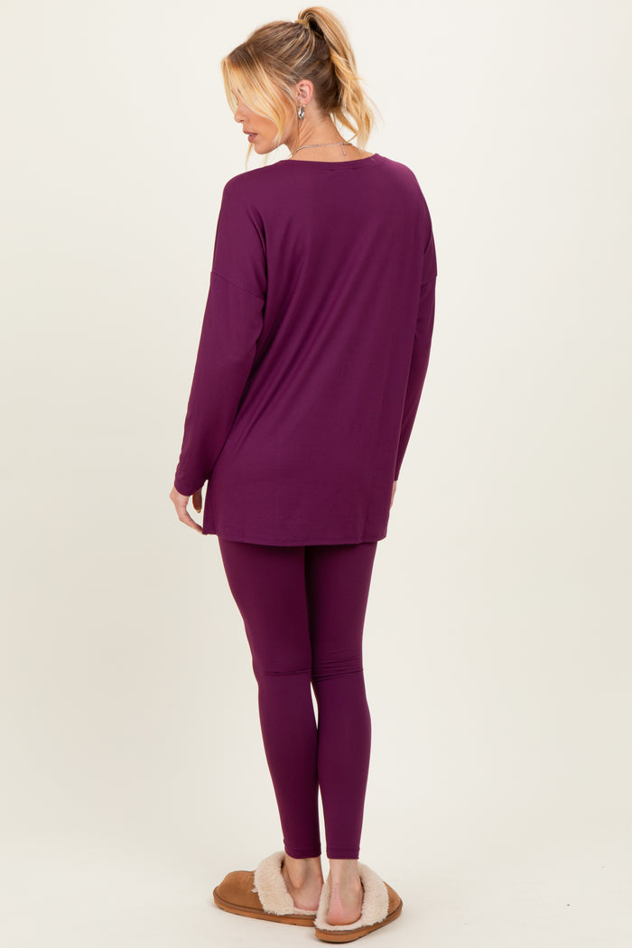 woman wearing a purple maternity loungewear set consisting of a long sleeve top and leggings, showing a relaxed fit