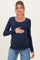 woman wearing a navy long sleeve maternity top and holding her baby bump