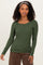 woman wearing a dark green long sleeve ribbed top with a scoop neckline and styled hair