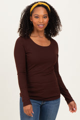 woman wearing a brown long sleeve ribbed top with a scoop neckline and styled with a yellow headband