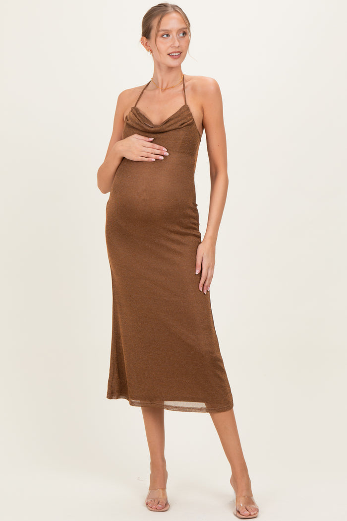 woman wearing a brown ribbed maternity dress with adjustable straps and a baby bump visible