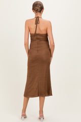 woman wearing a brown halter neck maternity dress with a fitted silhouette and midi length, showing her back