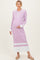 woman wearing a light purple ribbed maternity dress with a collar and buttons, showing her baby bump