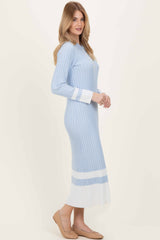 woman wearing a light blue ribbed long sleeve midi dress with white accent stripes and a fitted silhouette