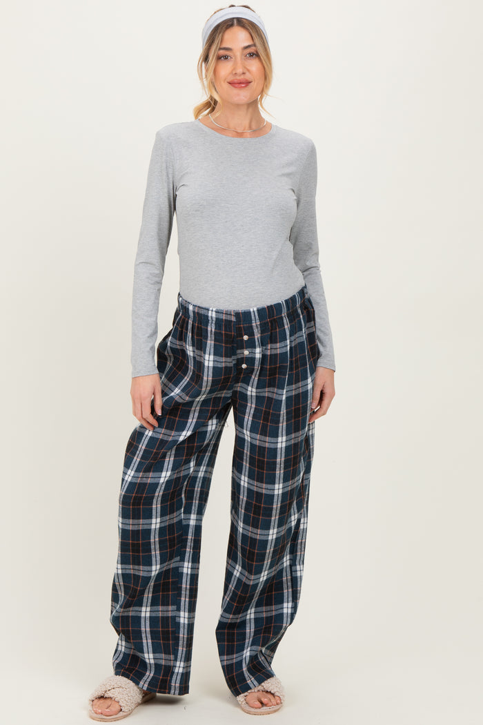 woman wearing a grey long sleeve maternity top and relaxed fit plaid maternity pajama pants with a headband