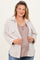 woman wearing a light beige corduroy shacket over a taupe maternity top and showing her baby bump